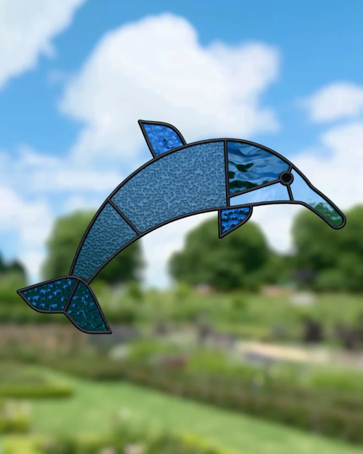 Dolphin suncatcher glazed, lit from behind.