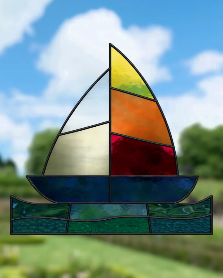 Sailboat suncatcher glazed, lit from behind.